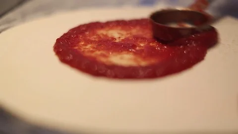 Making a Pizza - Spreading the Tomato Puree Stock Footage 77225683
