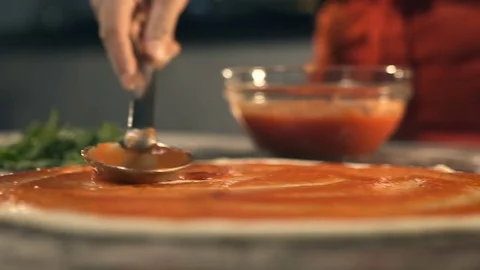Making Pizza, Spreading Tomato Sauce Stock Footage 74491209