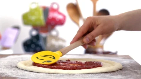 Making Pizza, Spreading Tomato Sauce Stock Footage 88630072