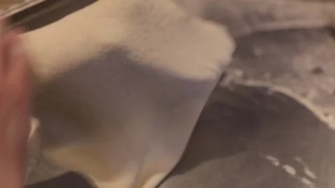 Making a Pizza - Stretching the Dough Stock Footage 77225743