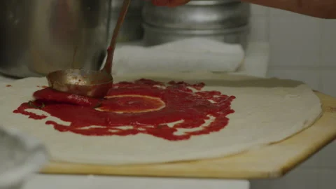 Making pizza working spreading tomato sauce italian restaurant kitchen Stock Footage 243700111