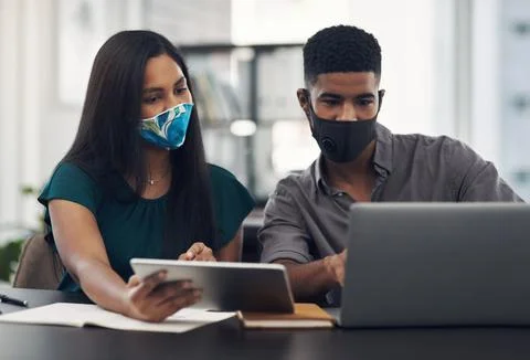 Making plans while adjusting to the new normal. two businesspeople working Stock Photos