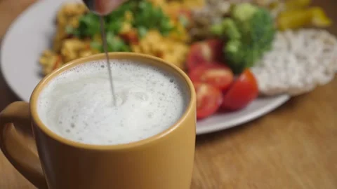 Making plant based milk drink for breakfast. Close up of frothing milk wit Stock Footage 139840857