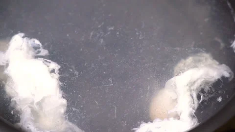 Making poached egg at home kitchen Stock Footage 249394267