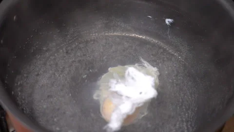 Making poached egg at home kitchen Stock Footage 249394428