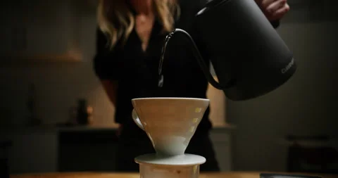 Making a pour over coffee with a gooseneck black kettle Stock Footage 247786382