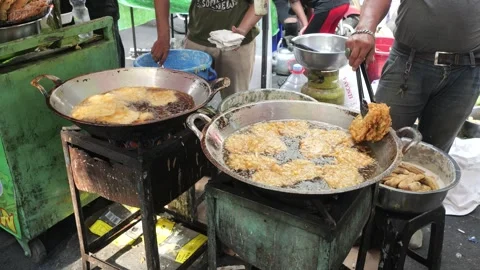 The Making Process of Tempe Mendoan Being Fried in Hot Cooking Oil Stock Footage 340468961