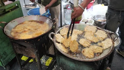 The Making Process of Tempe Mendoan Being Fried in Hot Cooking Oil Stock Footage 340469128
