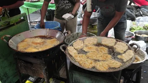 The Making Process of Tempe Mendoan Being Fried in Hot Cooking Oil Stock Footage 340469135