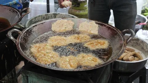 The Making Process of Tempe Mendoan Being Fried in Hot Cooking Oil Stock Footage 340469154