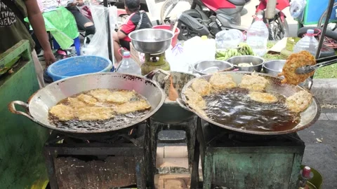 The Making Process of Tempe Mendoan Being Fried in Hot Cooking Oil Stock Footage 340469160