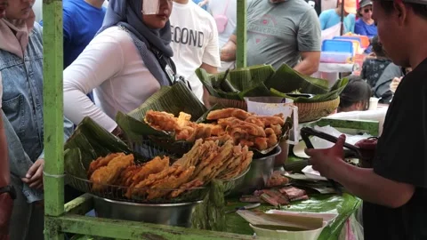 The Making Process of Tempe Mendoan Being Fried in Hot Cooking Oil Stock Footage 340469225
