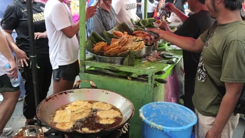 The Making Process of Tempe Mendoan Being Fried in Hot Cooking Oil Stock Footage 340469353