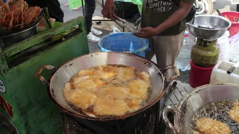 The Making Process of Tempe Mendoan Being Fried in Hot Cooking Oil Stock Footage 340469410