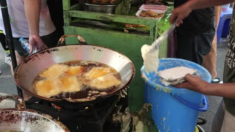 The Making Process of Tempe Mendoan Being Fried in Hot Cooking Oil Stock Footage 340469411