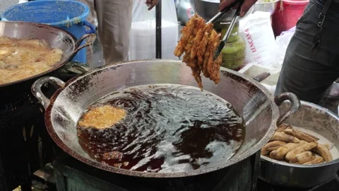 The Making Process of Tempe Mendoan Being Fried in Hot Cooking Oil Stock Footage 340469474