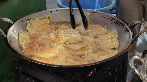 The Making Process of Tempe Mendoan Being Fried in Hot Cooking Oil Stock Footage 340469496