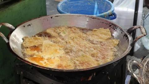 The Making Process of Tempe Mendoan Being Fried in Hot Cooking Oil Stock Footage 340469514