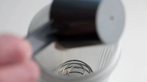Making protein cocktail. Serving a portion of protein powder Stock Footage 195938439