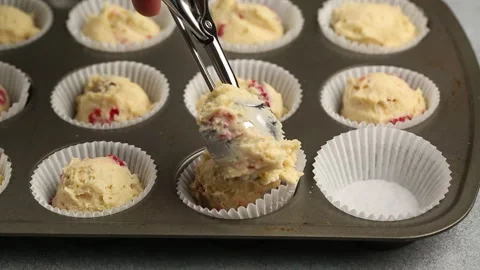 Making raspberry muffins with frosting and fresh berries Stock Footage 242603605
