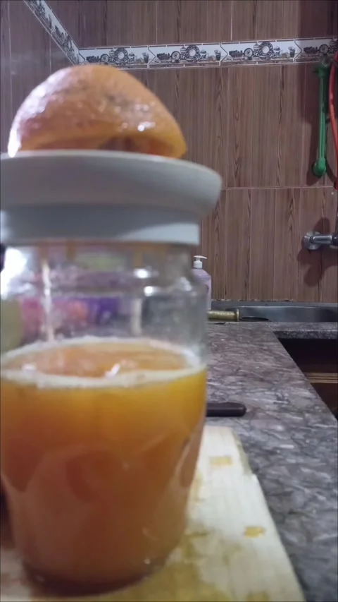 Making Raw Organic Orange Juice for Healthy Breakfast Stock Footage 336871975