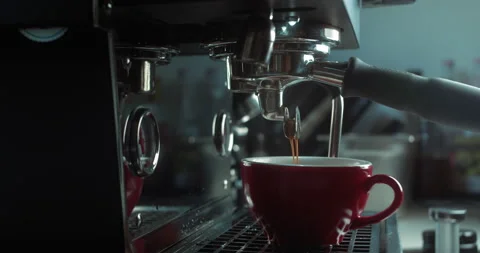 Making in red cup of strong coffee in a coffee machine, the back light Stock Footage 237722167