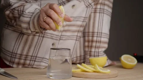 Making a refreshing drink with lemon and water Stock Footage 331423047