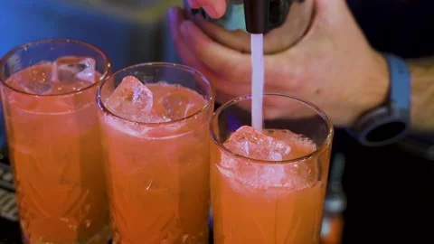 Making refreshing iced cocktail in tall glasses Stock Footage 314522219