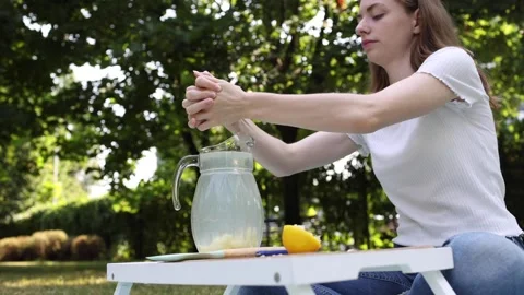 Making refreshing lemonade in a sunny garden on a summer afternoon Stock Footage 297370224