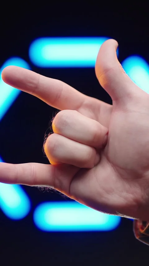 Making Rock and Roll Hand Symbol Over Neon Sign Circle Video stock 324572428