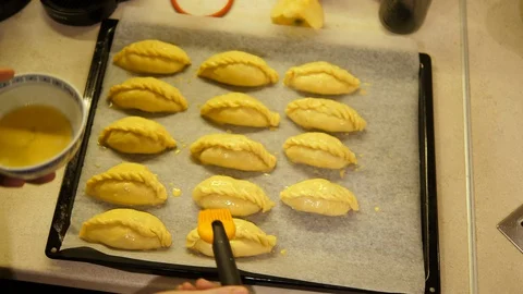 Making Rolls stuffing mince Beef on Tray ready to cook. Chef preparing Bun. Stock Footage 129455772