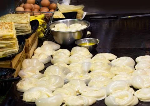 Making of Roti Canai, cooking process, Indian traditional street food Stock Photos