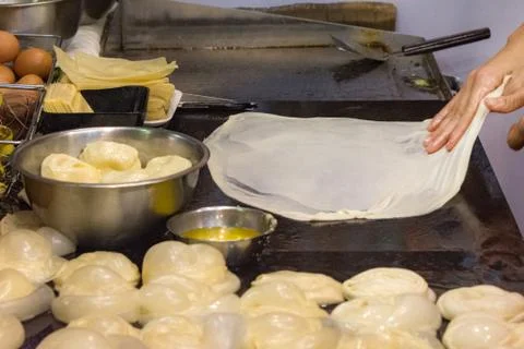 Making of Roti Canai, cooking process, Indian traditional street food Stock Photos