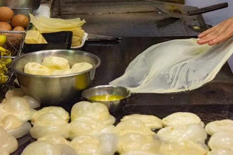 Making of Roti Canai, cooking process, Indian traditional street food Stock Photos