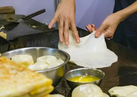 Making of Roti Canai, cooking process, Indian traditional street food Stock Photos