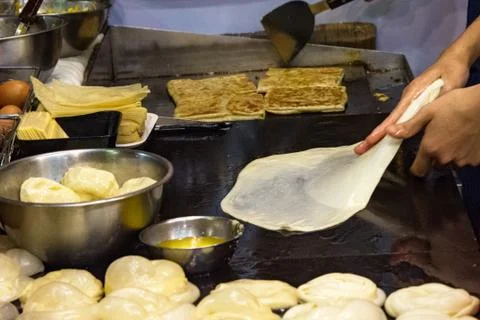 Making of Roti Canai, cooking process, Indian traditional street food Stock Photos