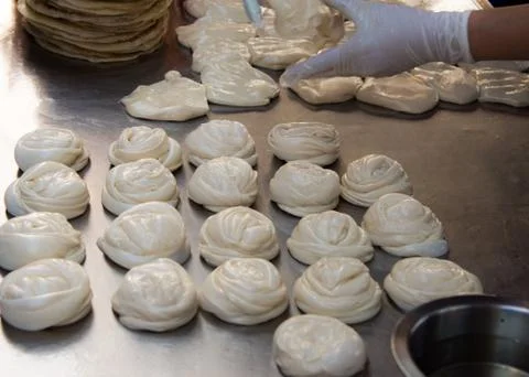 Making of Roti Canai, cooking process, Indian traditional street food Stock Photos