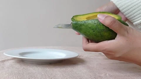 Making a salad with the fresh avocado Stock Footage 149957069