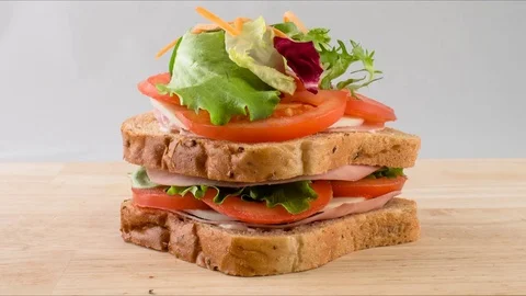 Making sandwich bread with tomato, ham, cheese, salad stop motion.  snack Stock Footage 77876495