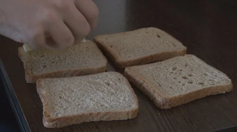 Making sandwich, closeup hand put pressed cheese slices and tasty ham on bread Stock Footage 45874513