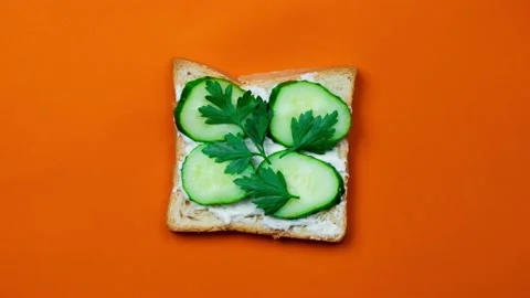 Making sandwich with cucumbers for breakfast. Stop motion animation Stock Footage 140989810