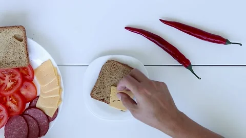 Making a Sandwich with Ham and Cheese Close-up. Hands Preparing a Ham Sandwich Stock Footage 247456837