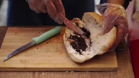 Making a sandwich with spread and bread in kitchen Видео 336160064