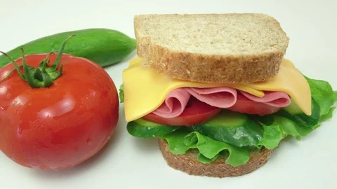 Making sandwich with tomato, ham, cheese and salad Stock Footage 89922558