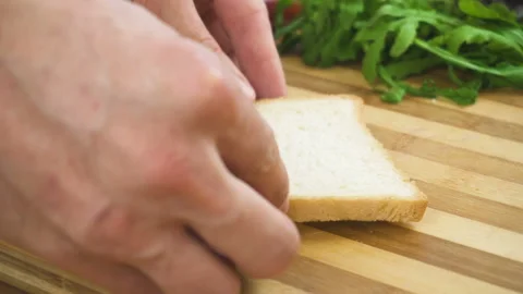 Making sandwich with white bread, ham, salad, tomatoes Stock-Footage 87824456