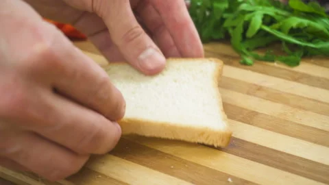 Making sandwich with white bread, ham, salad, tomatoes Stock Footage 88037027