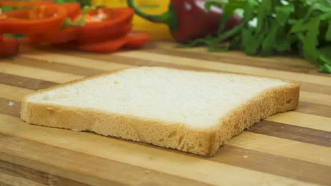 Making sandwich with white bread, ham, salad, tomatoes Stock Footage 88168833