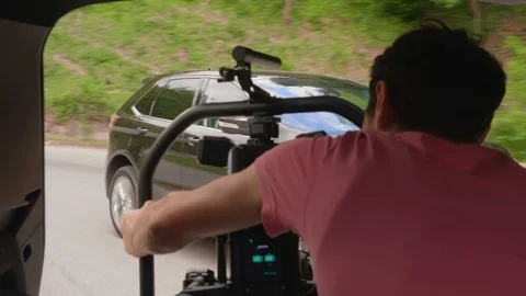 Making of scene of a camera operator filming a car Stock Footage 120354049