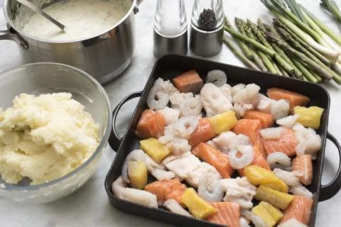 Making a seafood pie Stock Photos