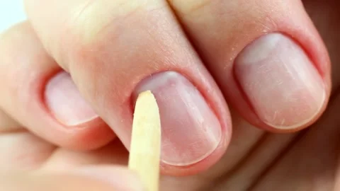 Making self manicure at home with the help of nail orange stick 스톡 동영상 224863990